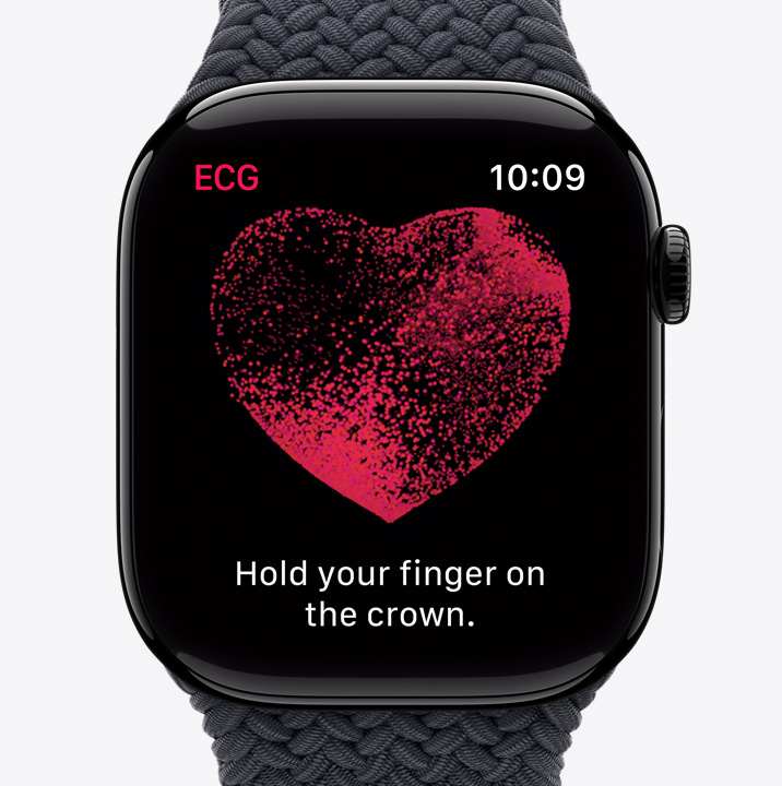 The ECG app screen on Apple Watch Series 10 showing a red heart with particles moving inside. Text says "Hold your finger on the crown."